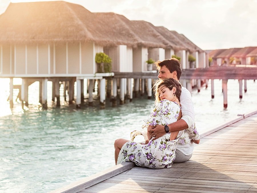nomad-maldives A couple sitting on a dock